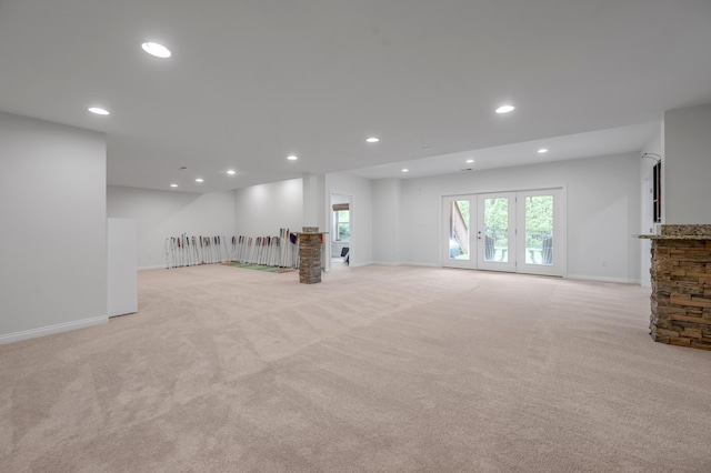 below grade area with light carpet, recessed lighting, and baseboards