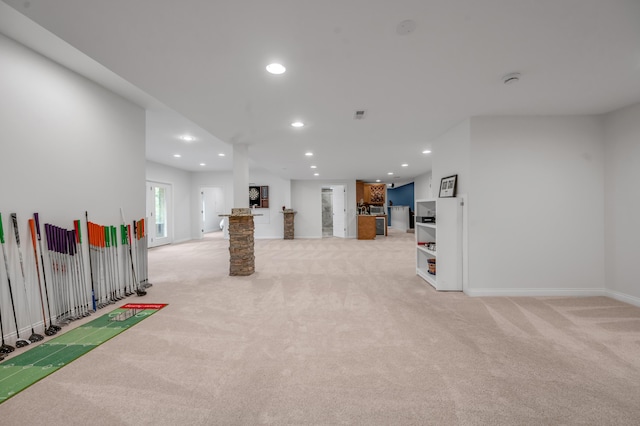 unfurnished living room with light colored carpet, recessed lighting, and baseboards