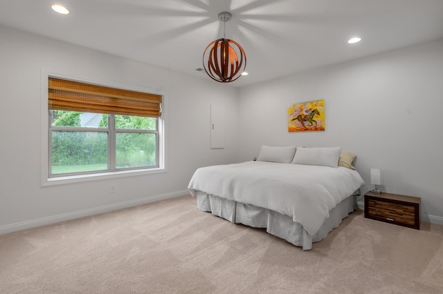 carpeted bedroom with baseboards, recessed lighting, and a chandelier