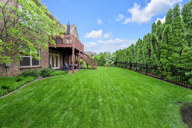 view of yard with a wooden deck, stairs, a patio, and french doors