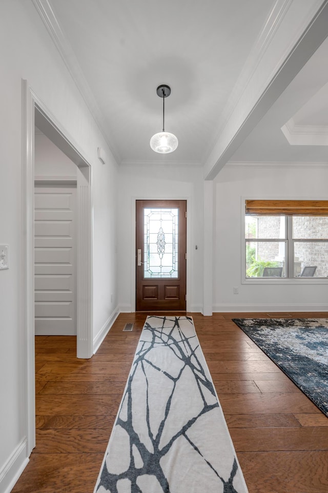 entrance foyer with healthy amount of natural light, crown molding, wood finished floors, and baseboards