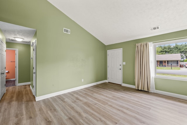 120 Chestnut Ln, Versailles, KY 40383 - unfurnished room featuring light wood finished floors, baseboards, a textured ceiling, and high vaulted ceiling