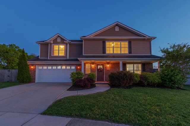 traditional-style house featuring an attached garage, driveway, and brick siding