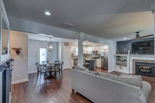 living area with a fireplace, a ceiling fan, baseboards, dark wood-type flooring, and recessed lighting