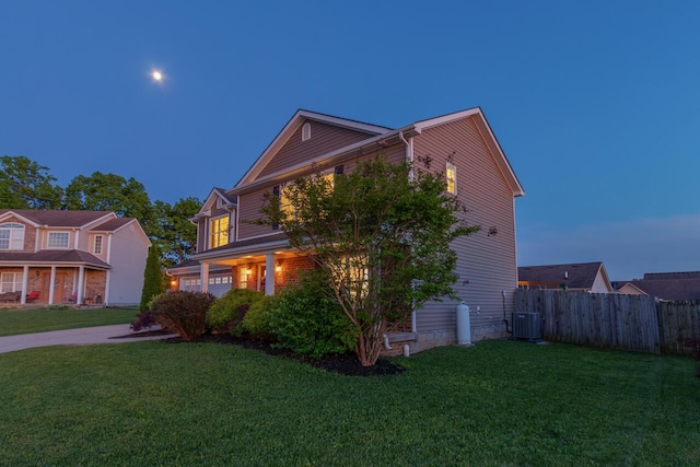 view of side of home featuring central AC, driveway, and an attached garage