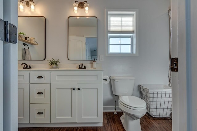 full bath with toilet, double vanity, wood finished floors, baseboards, and a shower with shower curtain