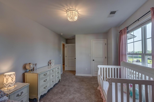 bedroom featuring light colored carpet and baseboards