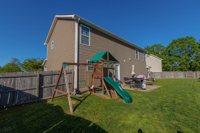 rear view of property featuring a playground