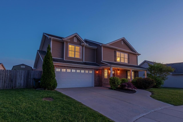 traditional-style home with driveway, a garage, and covered porch