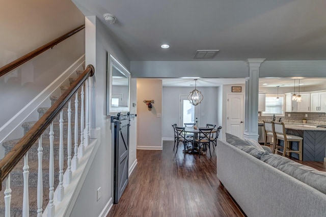 living room with dark wood-type flooring, baseboards, stairway, plenty of natural light, and recessed lighting