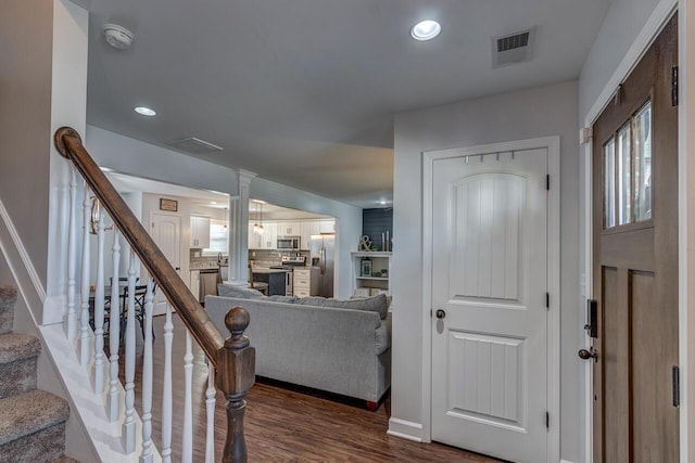 foyer entrance featuring dark wood-style floors, stairs, baseboards, and recessed lighting