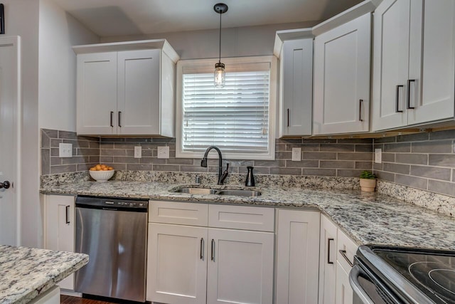 kitchen featuring dishwasher, a sink, white cabinets, and tasteful backsplash
