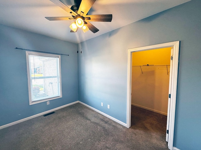 136 Janice Dr, Nicholasville, KY 40356 - unfurnished bedroom with a walk in closet, a closet, carpet floors, and baseboards