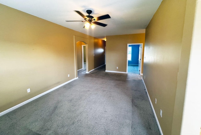 136 Janice Dr, Nicholasville, KY 40356 - unfurnished room with arched walkways, ceiling fan, baseboards, and dark colored carpet