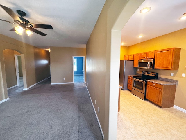 136 Janice Dr, Nicholasville, KY 40356 - kitchen with appliances with stainless steel finishes, arched walkways, brown cabinets, baseboards, and a ceiling fan