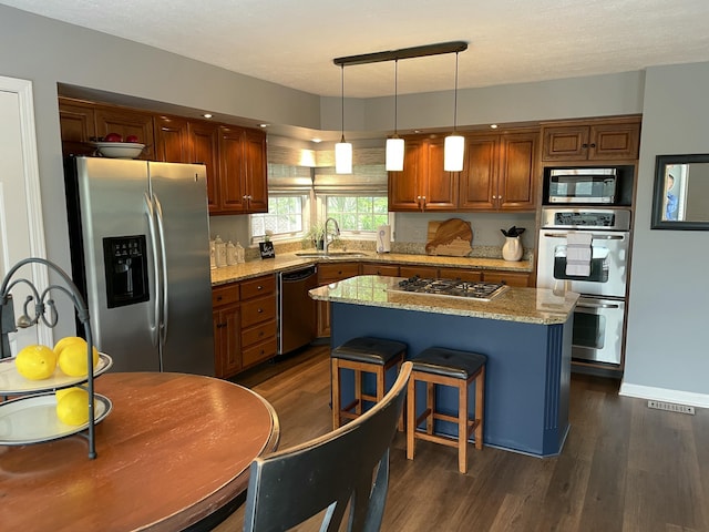 113 Paddock Ct, Frankfort, KY 40601 - kitchen with appliances with stainless steel finishes, a sink, dark wood-type flooring, and light stone counters