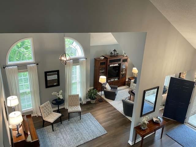 113 Paddock Ct, Frankfort, KY 40601 - living area featuring wood finished floors, high vaulted ceiling, a chandelier, and baseboards