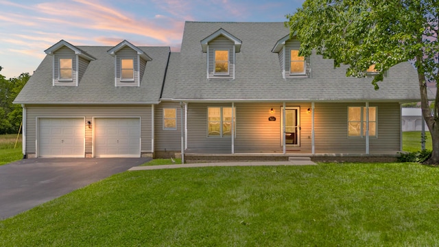 124 Cedar Dr, Berea, KY 40403 - cape cod house featuring a lawn, driveway, an attached garage, and a porch