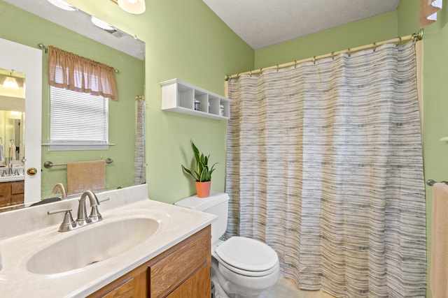 bathroom with toilet, vanity, and a shower with curtain