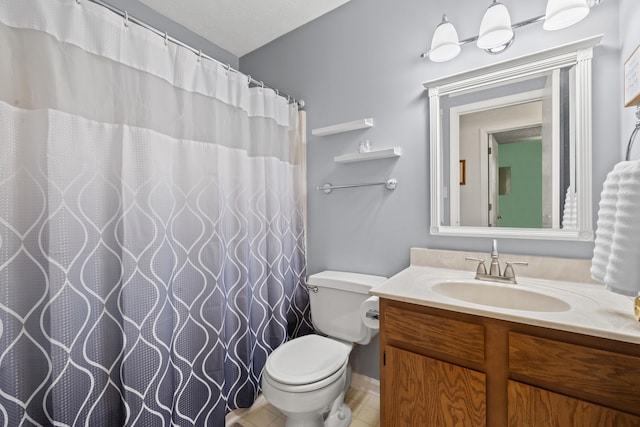 full bath with toilet, vanity, and tile patterned flooring