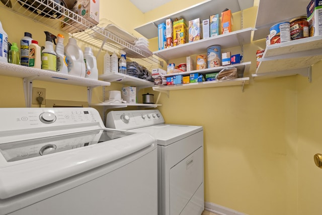 washroom with washing machine and clothes dryer