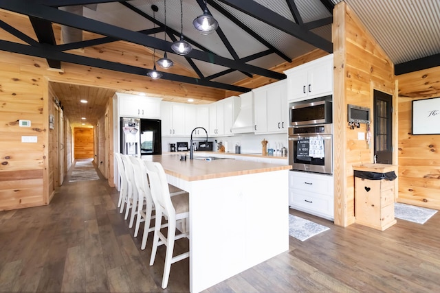 61 Cumberland Cv, Nancy, KY 42544 - kitchen with appliances with stainless steel finishes, wooden walls, a sink, dark wood finished floors, and light countertops