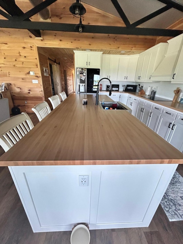61 Cumberland Cv, Nancy, KY 42544 - dining space with wooden walls, beam ceiling, and dark wood-style floors