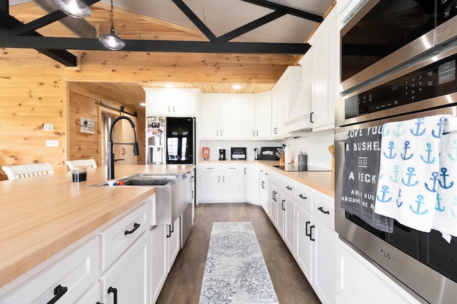 61 Cumberland Cv, Nancy, KY 42544 - kitchen featuring appliances with stainless steel finishes, light countertops, wood walls, white cabinetry, and wood ceiling