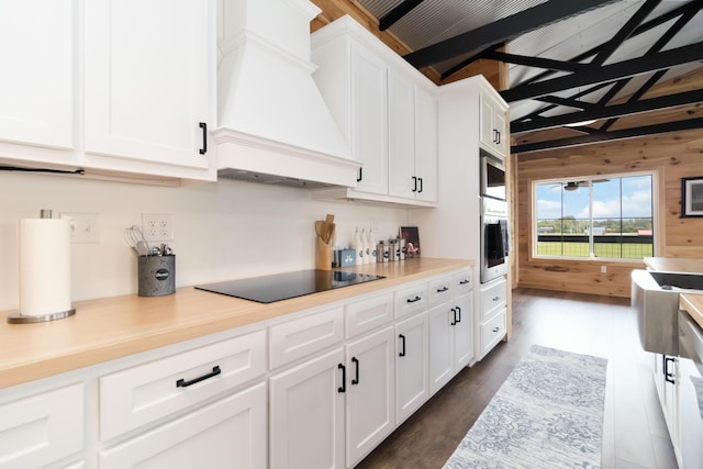 61 Cumberland Cv, Nancy, KY 42544 - kitchen with stainless steel appliances, premium range hood, white cabinetry, light countertops, and wood walls