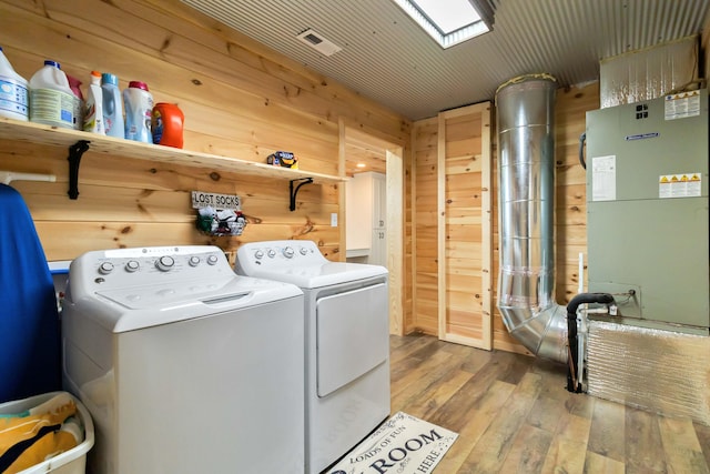61 Cumberland Cv, Nancy, KY 42544 - laundry area featuring washer and clothes dryer, hardwood / wood-style floors, wooden walls, and heating unit