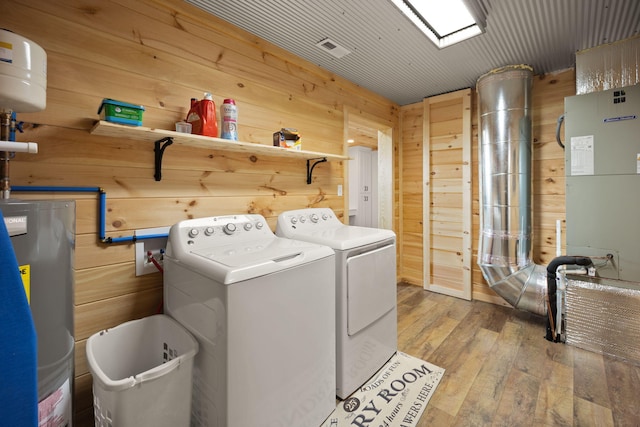 61 Cumberland Cv, Nancy, KY 42544 - laundry room featuring water heater, washing machine and clothes dryer, wood walls, and light wood finished floors