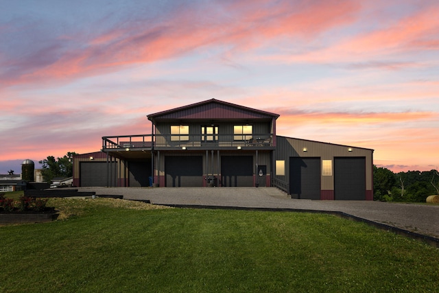 61 Cumberland Cv, Nancy, KY 42544 - back of property at dusk featuring gravel driveway, a lawn, and a wooden deck
