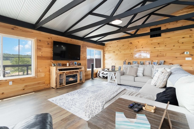 61 Cumberland Cv, Nancy, KY 42544 - living area featuring wood walls, wood finished floors, beamed ceiling, high vaulted ceiling, and a glass covered fireplace