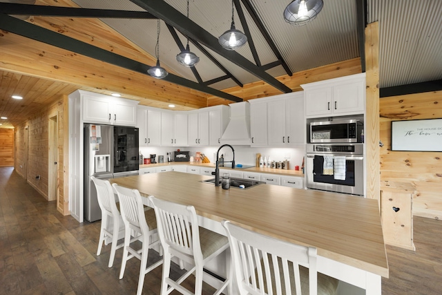 61 Cumberland Cv, Nancy, KY 42544 - kitchen with stainless steel appliances, wood walls, dark wood-style floors, light countertops, and white cabinetry