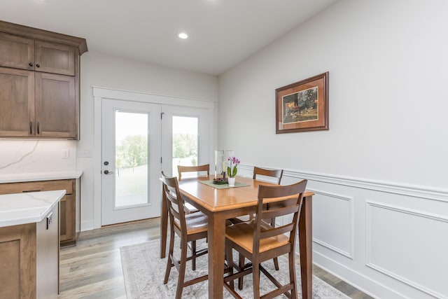 269 Ashley Camp Rd, Harrodsburg, KY 40330 - dining space featuring wainscoting, light wood-style flooring, recessed lighting, and a decorative wall