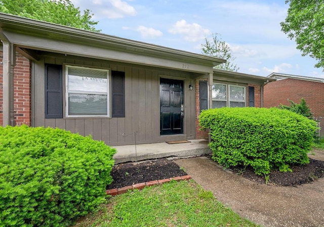 doorway to property with brick siding