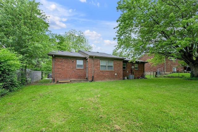 back of property featuring brick siding and central air condition unit