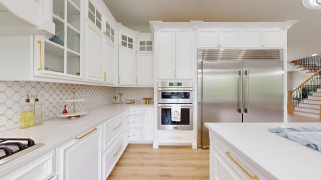 840 A T Dean Rd, Harrodsburg, KY 40330 - kitchen featuring stainless steel appliances, white cabinets, light wood-style flooring, and backsplash