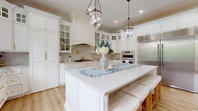 840 A T Dean Rd, Harrodsburg, KY 40330 - kitchen featuring stainless steel appliances, light wood-style floors, a center island, white cabinets, and light countertops