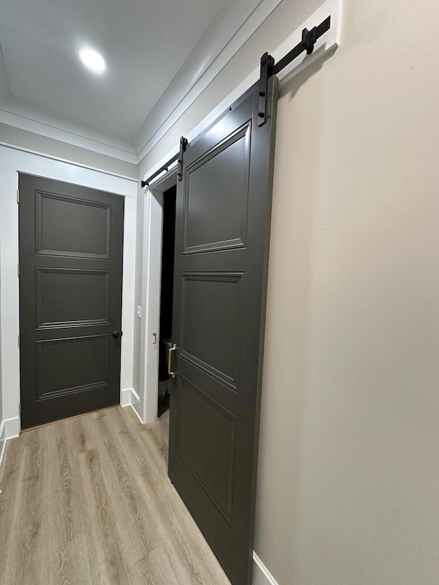 840 A T Dean Rd, Harrodsburg, KY 40330 - hallway featuring a barn door, light wood-type flooring, and baseboards
