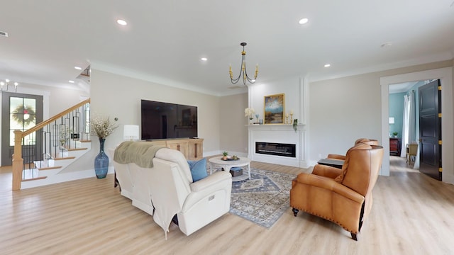 840 A T Dean Rd, Harrodsburg, KY 40330 - living area with a chandelier, wood finished floors, stairway, a glass covered fireplace, and recessed lighting