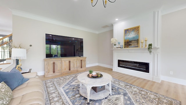 840 A T Dean Rd, Harrodsburg, KY 40330 - living area with crown molding, wood finished floors, a glass covered fireplace, baseboards, and stairway
