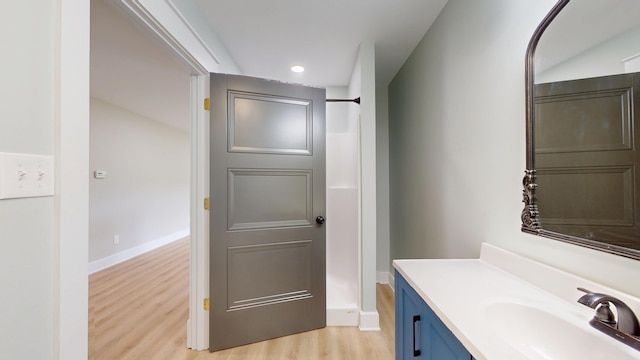 840 A T Dean Rd, Harrodsburg, KY 40330 - bathroom featuring wood finished floors, vanity, recessed lighting, baseboards, and a shower