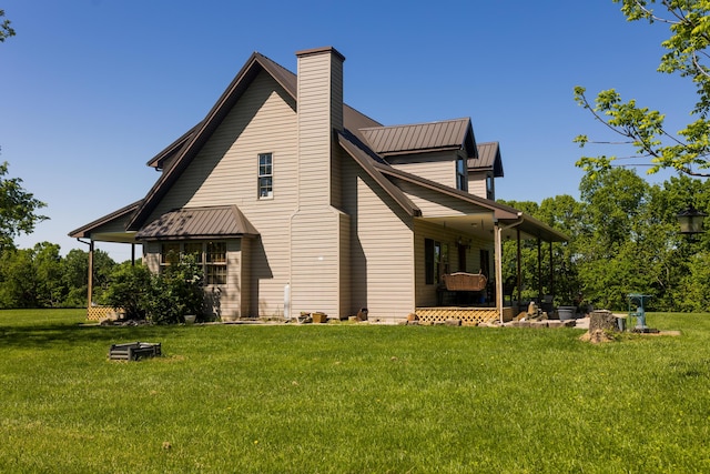 388 Mc Roberts Rd, Wallingford, KY 41093 - rear view of house featuring a lawn, a chimney, and metal roof