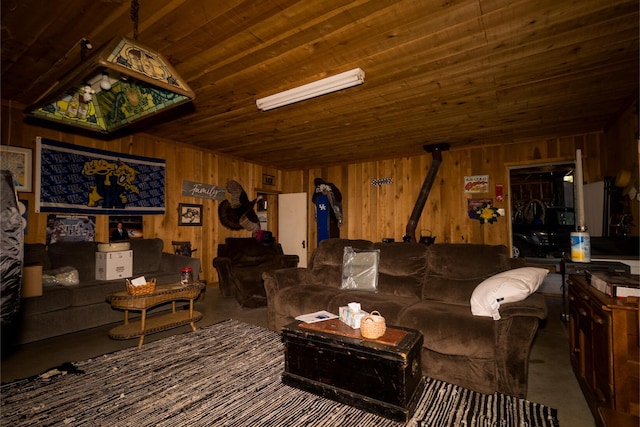 388 Mc Roberts Rd, Wallingford, KY 41093 - living area with a wood stove, wood walls, wooden ceiling, and finished concrete floors