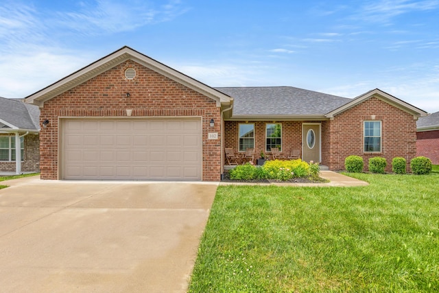 ranch-style house with brick siding, driveway, a front yard, an attached garage, and roof with shingles