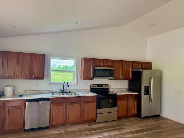 439 Logan Antle Rd, Jamestown, KY 42629 - kitchen featuring appliances with stainless steel finishes, a sink, light countertops, high vaulted ceiling, and light wood finished floors