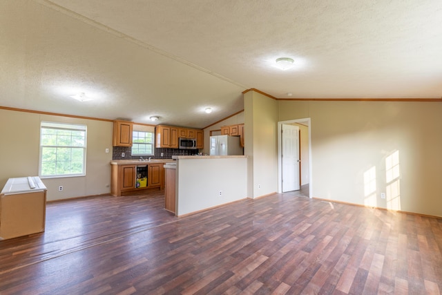 662 Clifty Hill Rd, Science Hill, KY 42553 - kitchen featuring freestanding refrigerator, stainless steel microwave, open floor plan, dark wood-style flooring, and crown molding