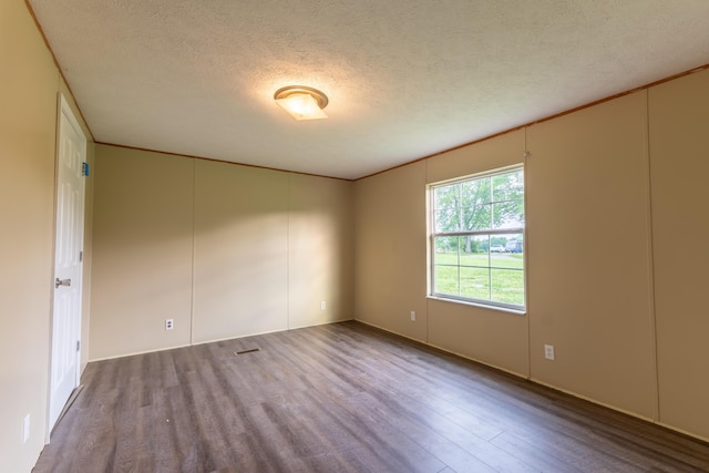 662 Clifty Hill Rd, Science Hill, KY 42553 - unfurnished room featuring wood finished floors, a textured ceiling, and ornamental molding