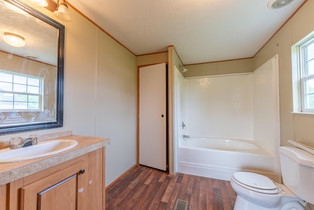 662 Clifty Hill Rd, Science Hill, KY 42553 - full bath with toilet, wood finished floors, shower / bath combination, vanity, and a textured ceiling